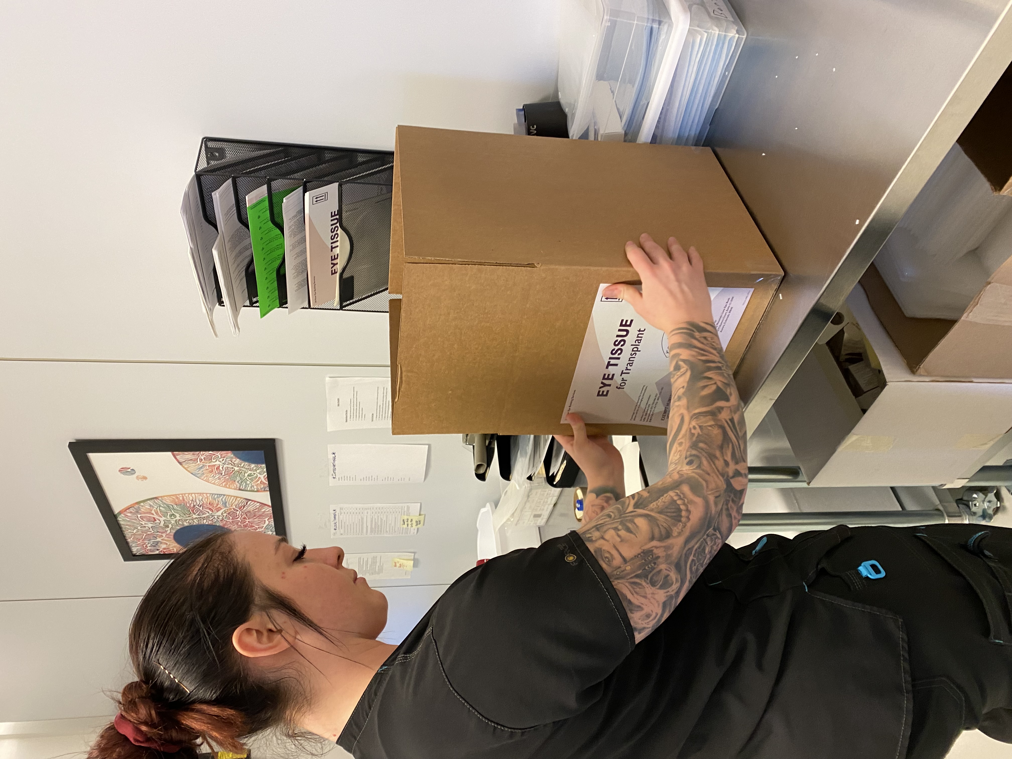 claire mundt packaging eye tissue in shipping box to send the corneas to eye surgeons for a cornea transplant in rocky mountain lions eye bank lab