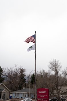 flag being raised outside of a hospital