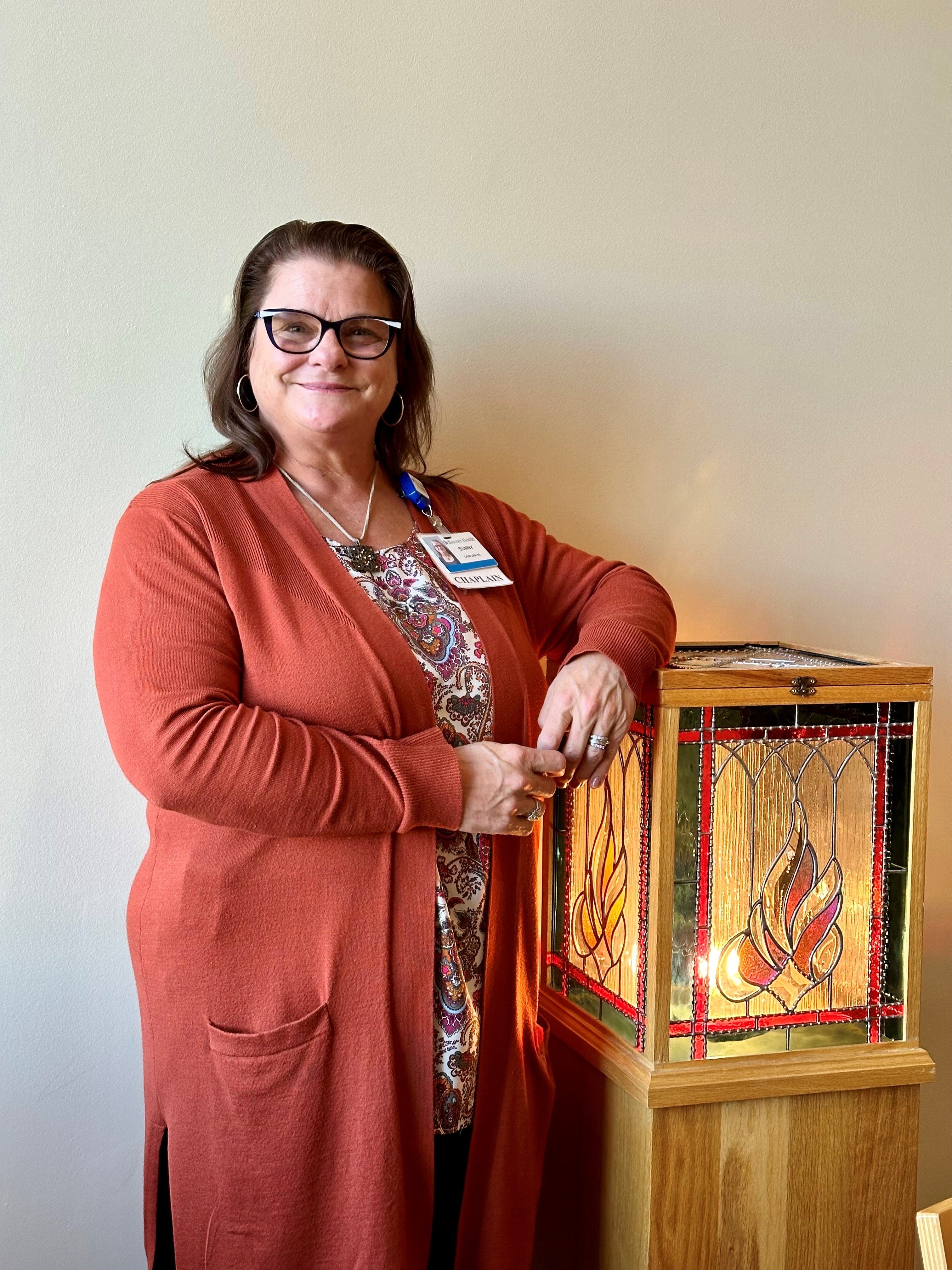 Chaplain Sunny standing next to the eternal flame in the chapel at Banner Wyoming Medical Center in Casper Wyoming.